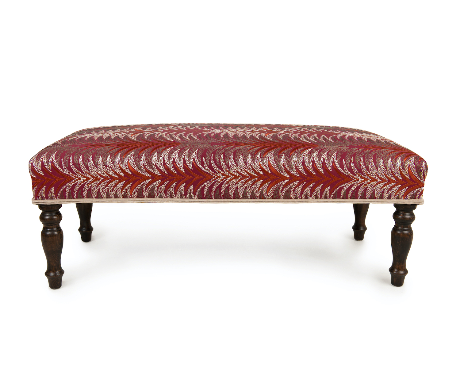 Striking Wrapover Footstool with Contrast Double Piping and Turned Legs